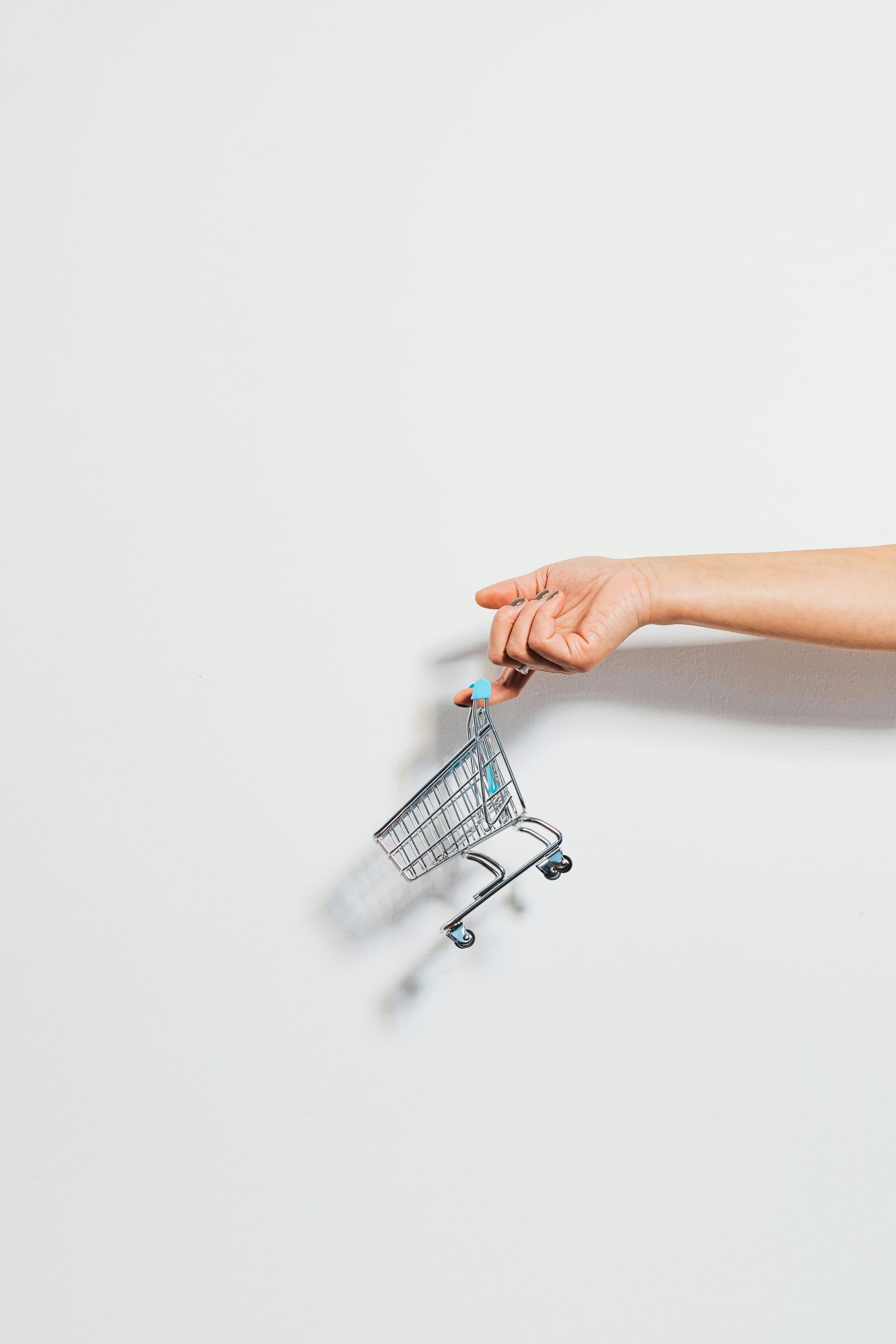 online store cart with a hand in white 